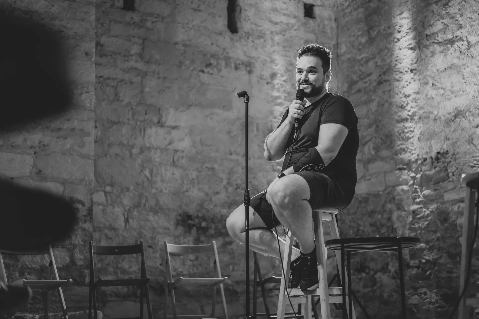 Arsenii Stanis on stage with a microphone